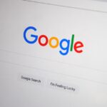 Close-up of the Google homepage on a screen showing search options.